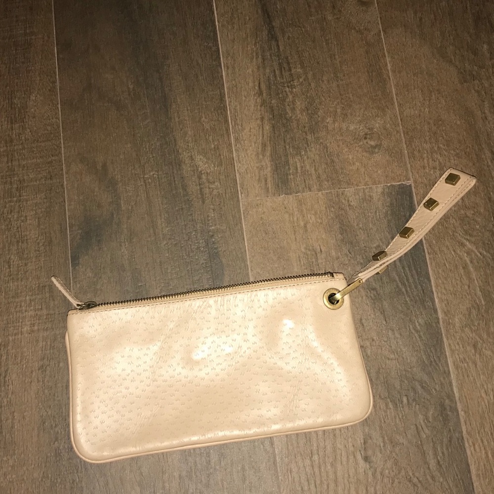 Tan Adrienne Vittadini clutch with studded strap
